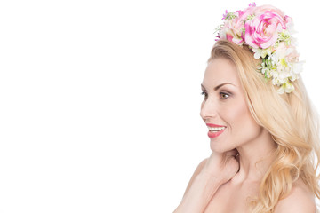 Loving what I see. Beautiful mature woman wearing a flower wreath smiling excitedly looking at the...