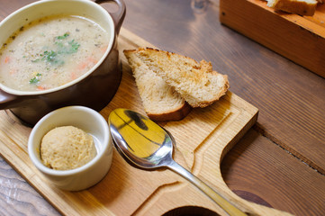 Soup with croutons on the wooden table