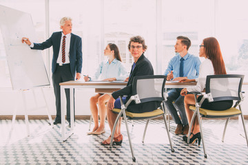 Confident woman sitting at business training