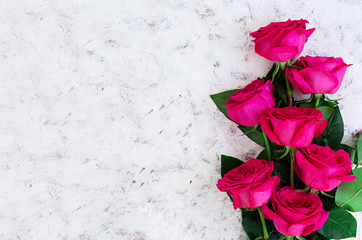 Fototapeta na wymiar Bouquet of pink roses on dark background. Top view