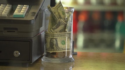 A full tip jar near register