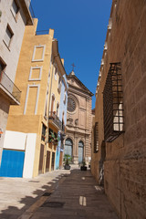 Fototapeta na wymiar Ancient church in the old street in Valencia
