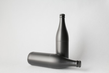 The composition of two bottles: one stands and the other is tipped over