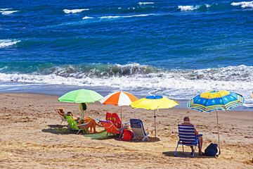 People sunbathing on beach in Mediterranean Sea in Marbella