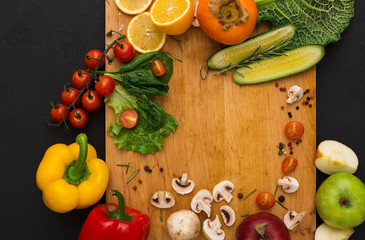 Frame of fresh vegetables on wooden background with copy space