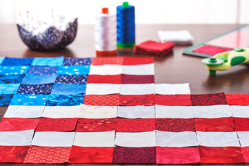 Fototapeta na wymiar Preparing to sewing of pieces of fabrics that look like a flag of USA