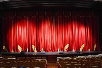 Obraz premium red theatre curtain with gold tassels and embroidery. the stage