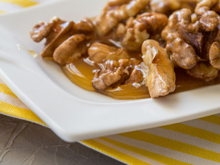 Honey in white jar, nuts, top view
