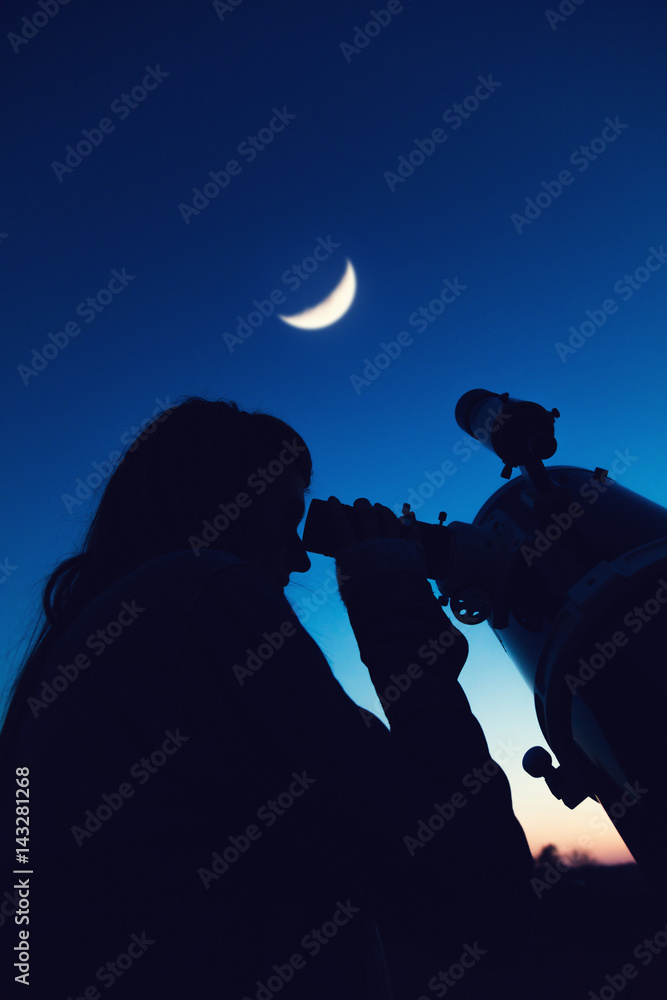 Wall mural girl looking at the moon through a telescope. my astronomy work.