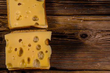 Sandwich with cheese on wooden table