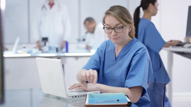  Medical team working together, using technology & looking at x-rays