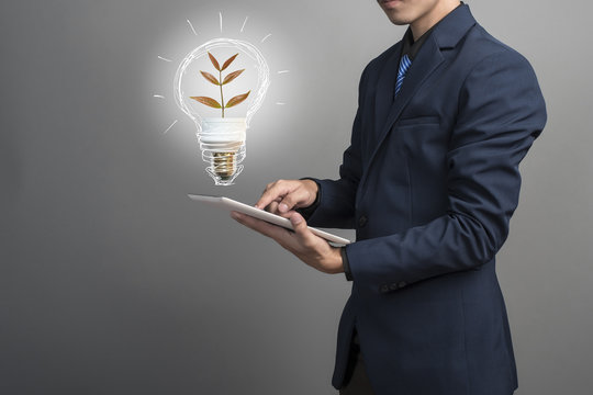 Idea lamp in businessman hand, save earth concept