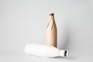 The composition of two bottles: one stands and the other is tipped over