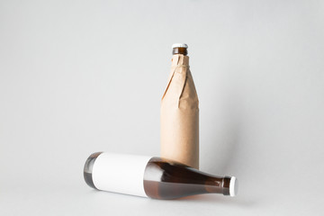 The composition of two bottles: one stands and the other is tipped over
