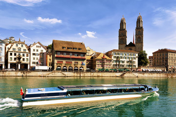 River Cruiser in Limmat and Grossmunster Church in Zurich