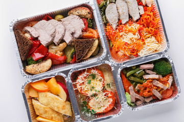 Healthy food take away in boxes, top view at wood