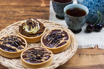 tartlets, basket cakes, sweet, tea on the wodden table