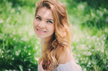 Naklejka premium beautiful young woman in floral maxi skirt walking in spring