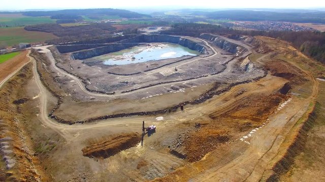   Camera flight over a open cast mine. Industrial landscape. Heavy industry from above. 


