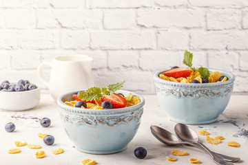 Healthy breakfast - corn flakes with fruits and berries.