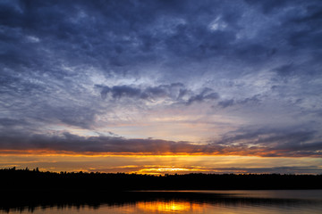 Fototapeta na wymiar Colorful Swedish sunset over water in the Stockholm archipelago