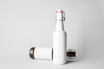 The composition of two bottles: one stands and the other is tipped over