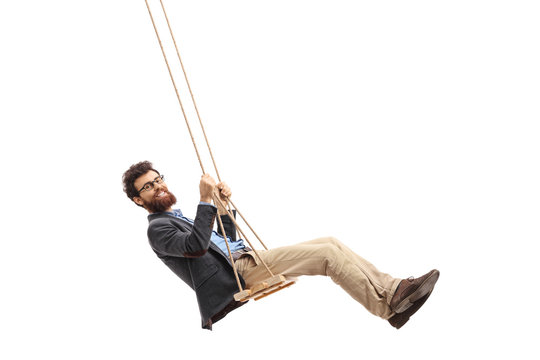 Bearded man swinging on a swing