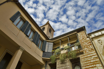 View from below on a beautiful balcony against a blue sky. A small European city.