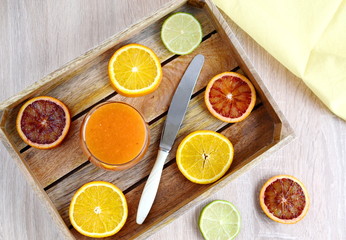 Orange juice in glass and fresh fruits on wooden background, vitamin drink