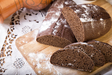 Sliced rye bread on a Board. On a wooden table.