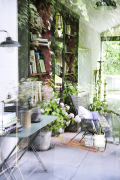 Reflections in the glass of a house and view of the interior decoration industrial and vintage style and garden