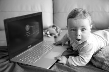 Kid is playing with computer