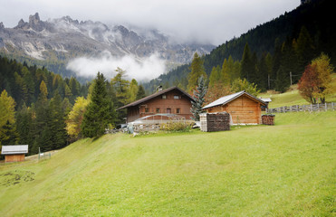 Fototapeta na wymiar Beautiful autumn landscape with cottages - the road to Gardeccia refuge, Dolomites Mountains, Italy, Europe