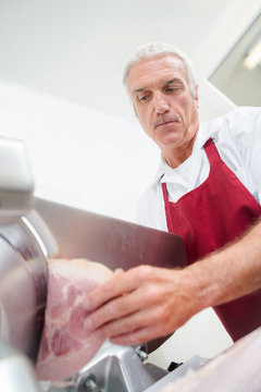 butcher slicing ham