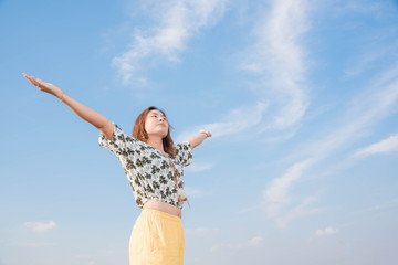 Young woman happy in summer sunlight sky outdoor. summer concept