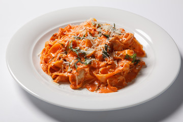 Pasta tagliatelle with tomato isolated on white background