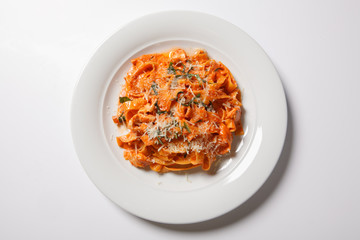 Pasta tagliatelle with tomato isolated on white background
