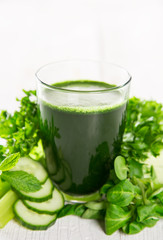 Healthy green smoothie in a glass with vegetables.