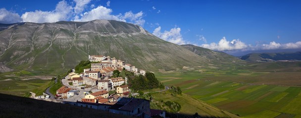 The olf village of Castelluccio before the disastrous earthquake of 2016 in the background the fields planted with lentil, Italy