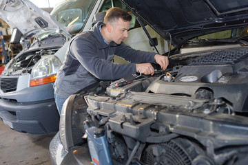 mechanic working on a broken down vehicle