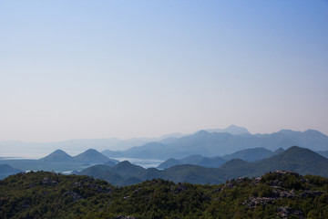 The mountainous landscape: the mountains, the sky, mountain lakes, heavenly gradient. Silhouette of the mountains against the sky.