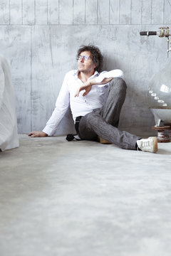 Architect sitting on the floor at construction site