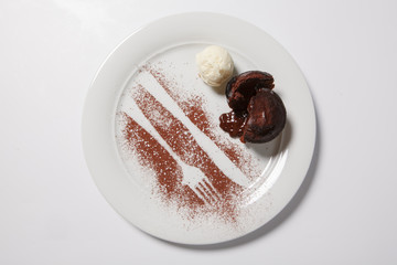 Lava cake with ice cream on a white plate.