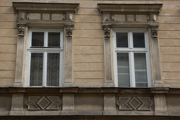 Fototapeta na wymiar Two vintage design green windows on the facade of the old house
