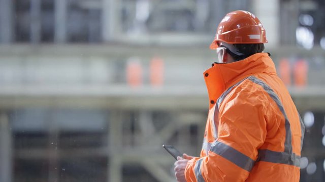  Portrait of smiling engineer in the power industry holding a walkie talkie