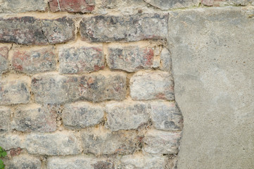 Old wall where concrete has been broken off.