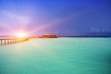 Obraz premium The wooden road over the sea to the tropical island.