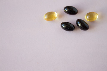astaxanthin and fish oil. Gel capsules on white background