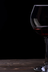 wineglass with wine on black background