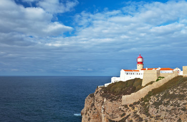 Fototapeta na wymiar Coastal lighthouse on the Cape S.Vicente autumn cloudy morning, Sagres, Cabo de S.Vicente, Algarve, Portugal